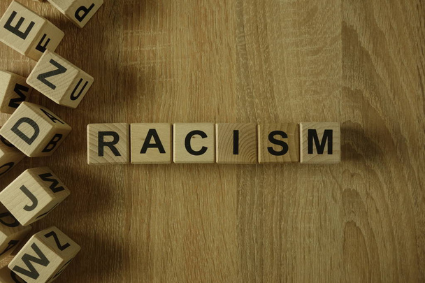 Racism word from wooden blocks on desk - Fotoğraf, Görsel