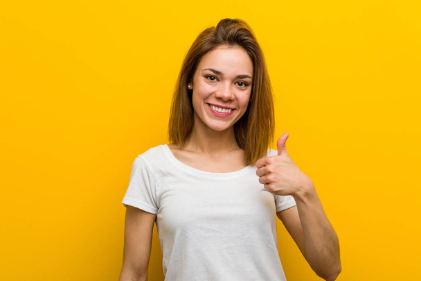 Young natural caucasian woman smiling and raising thumb up - Photo, image