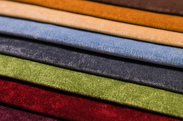 Close-up diagonal lines of textile upholstery in samples to select the color and fabric of the furniture. Abstract multicolored background - Foto, afbeelding