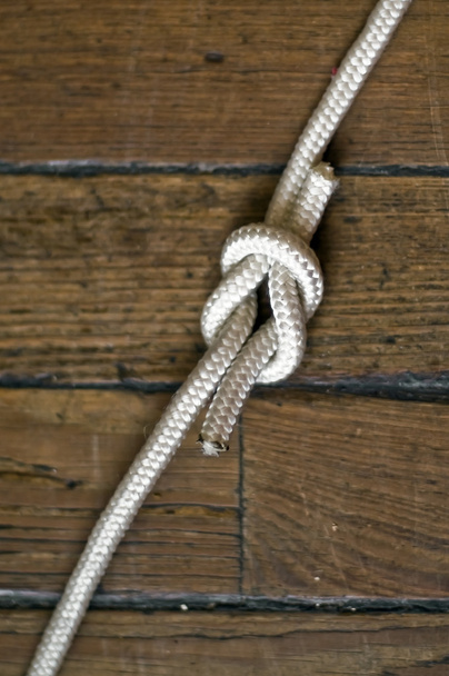 Reef knot over the wooden background - Photo, Image