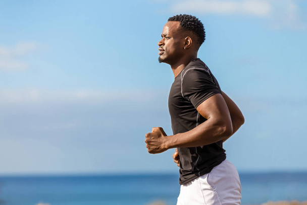 Black african american young man running outdoor - 写真・画像