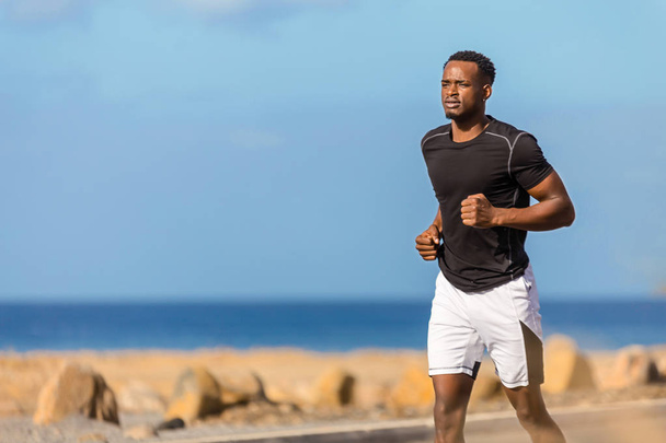 Black african american young man running outdoor - Foto, Bild