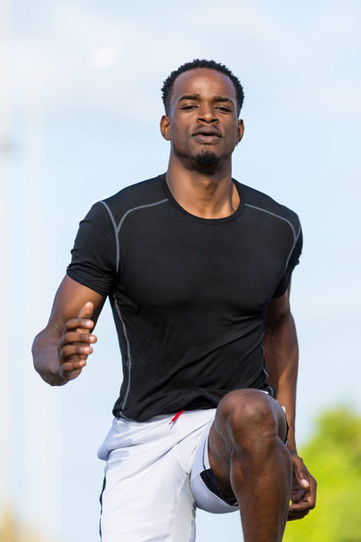 Black african american young man running outdoor - Foto, Imagen