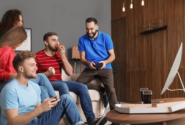 Emotional friends playing video games at home - Fotó, kép