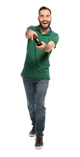 Emotional young man playing video games with controller isolated on white - Foto, Imagen