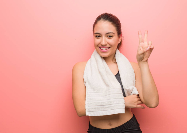 Young fitness woman showing number two - Photo, Image