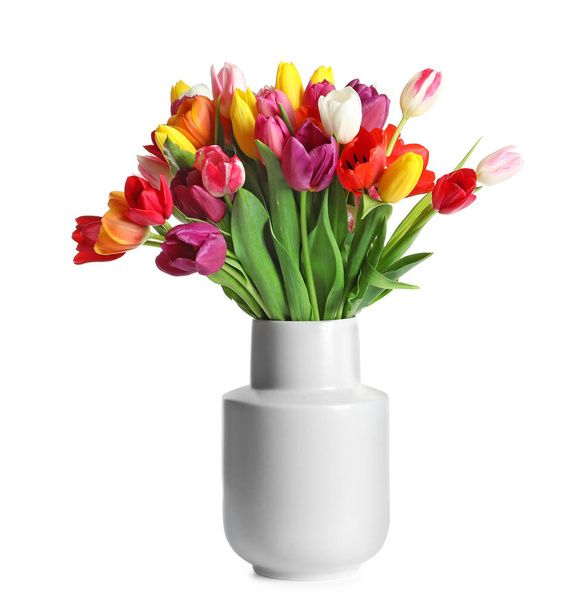 Vase with beautiful spring tulip flowers on white background - 写真・画像