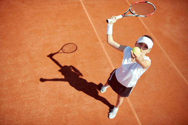 Tennis player serving ball   - 写真・画像