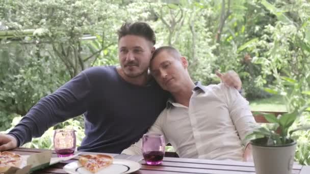 Caucasian gay couple have romantic dinner at garden  - Felvétel, videó