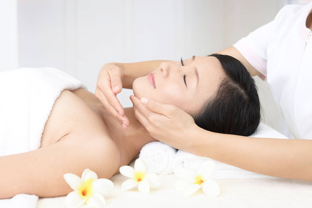 Beautiful young woman receiving facial massage - Photo, Image