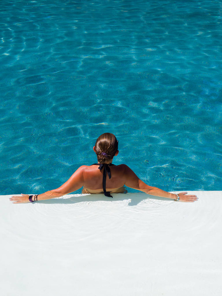 woman in luxury spa resort near the swimming pool.  - Photo, image