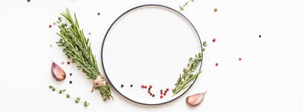 Empty plate with greens herbs and spices around - Fotografie, Obrázek