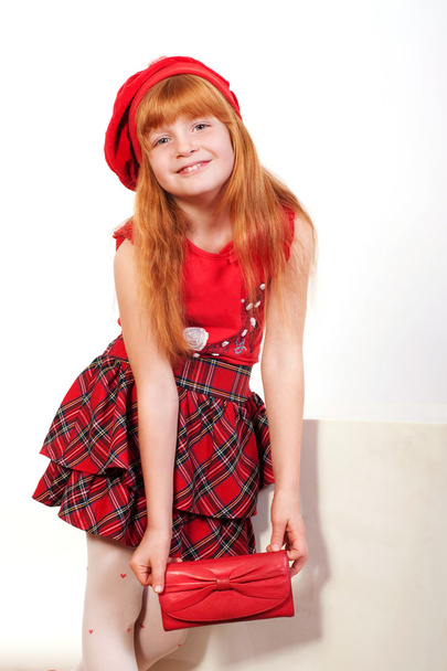 Little redheaded girl in red - Φωτογραφία, εικόνα