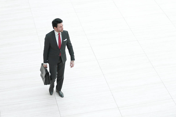 far away.business man with leather briefcase is coming - Photo, image