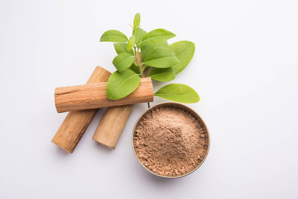 Chandan or sandalwood powder with sticks and green leaves - Photo, Image