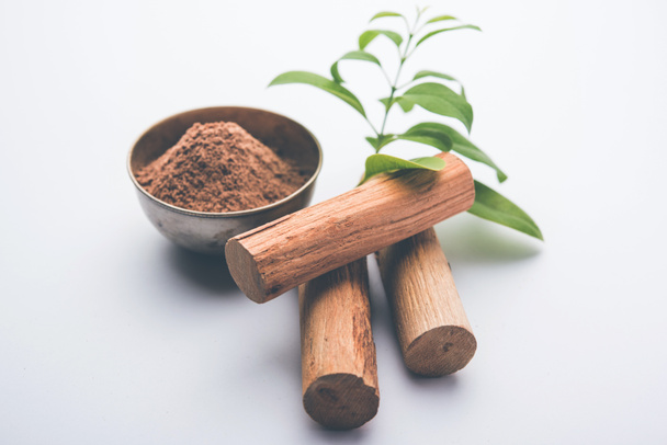 Chandan or sandalwood powder with sticks and green leaves - Photo, Image