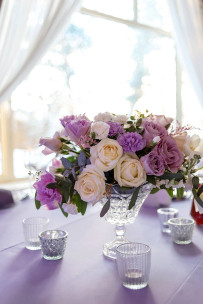Beautiful bouquet in a crystal vase on a table - Photo, Image