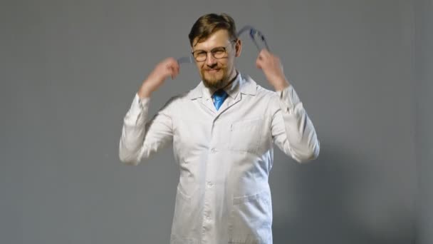 doctor man in white coat on gray background, medicine concept - Footage, Video