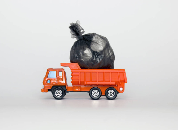toy garbage truck with garbage bags isolated on white background - Photo, Image