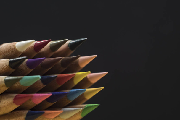 sharp colored pencils on a black background. copy space - Fotografie, Obrázek