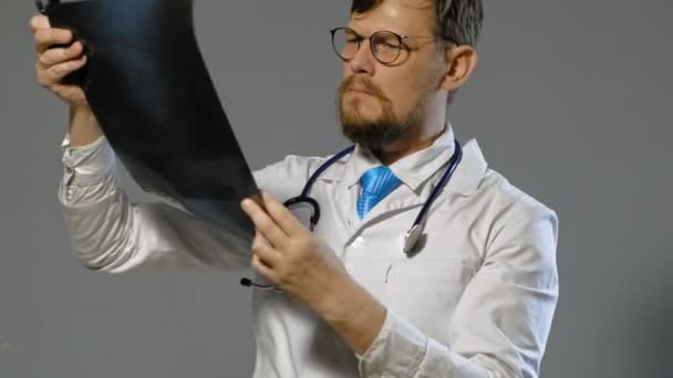 doctor man in white coat on gray background, medicine concept - Záběry, video