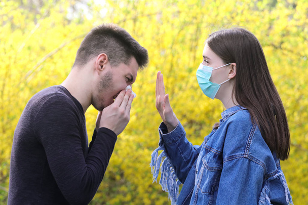 Girl with protective mask and sick sneezing boy, stop the flu  e - Fotografie, Obrázek