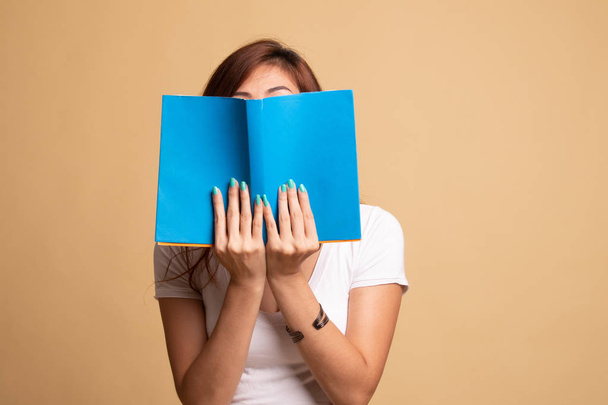 Young Asian woman with a book cover her face. - Fotografie, Obrázek