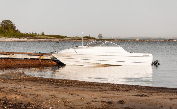 Motor boat parking aside rusty quay - Photo, Image