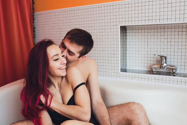 Man hugs woman from behind lying in the bath. - Fotó, kép