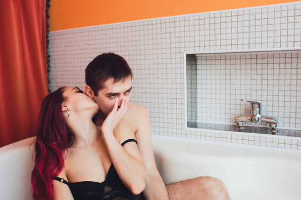 Man hugs woman from behind lying in the bath. - Valokuva, kuva