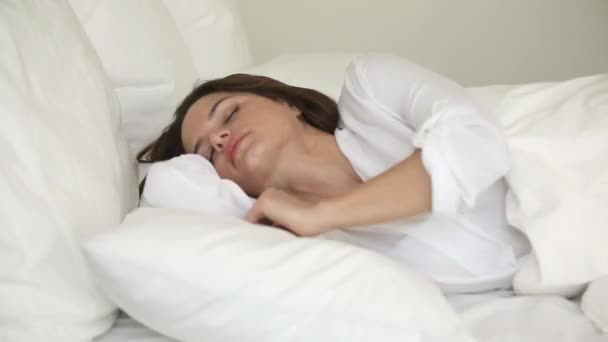 Young woman tossing and turning in bed suffer from insomnia - Felvétel, videó