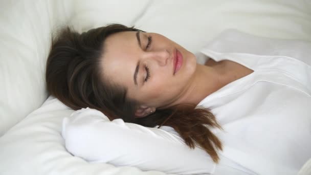 Calm woman with beautiful face sleeping well in comfortable bed - Materiaali, video