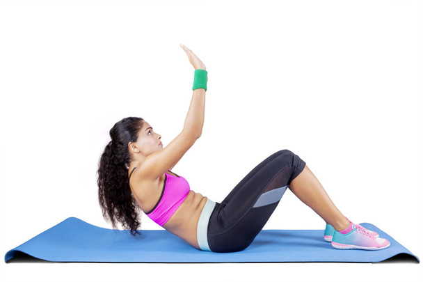 Curly hair woman doing crunches exercises - Foto, Imagen