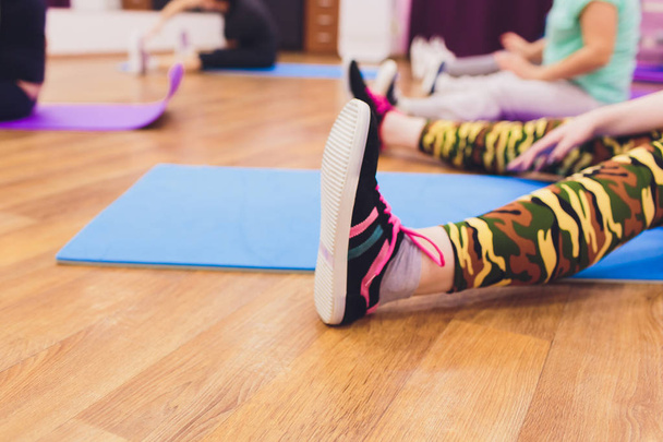 Fitness background, copy space, sport urban style, slim female legs, yoga mat. - Фото, зображення