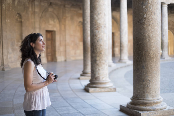 Tourist woman taking pictures to La Alhambra in sunny day. Carlos V palace - Φωτογραφία, εικόνα