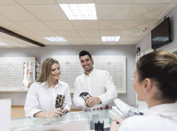 Couple shopping in optical store glasses - Foto, Imagen