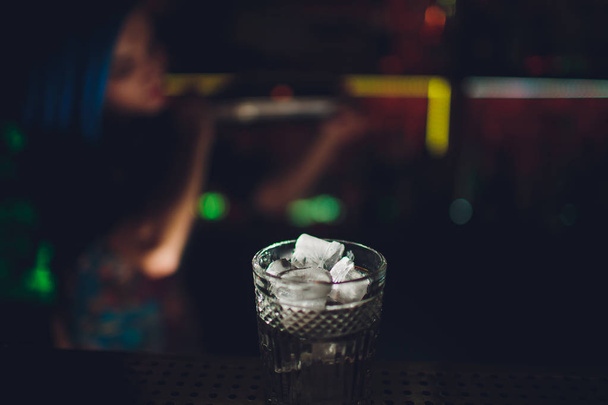 female bartender. girl with blue hair. cocktail making in night bar. - Fotó, kép