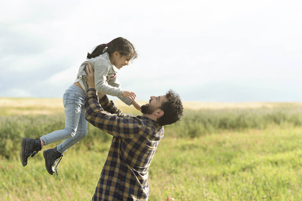 Father and daughter playing outdoors - Photo, image