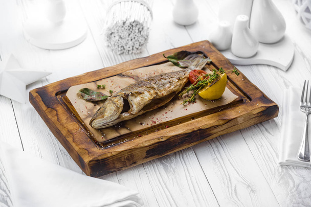 Spicy grilled fish with seasoning on a board - 写真・画像