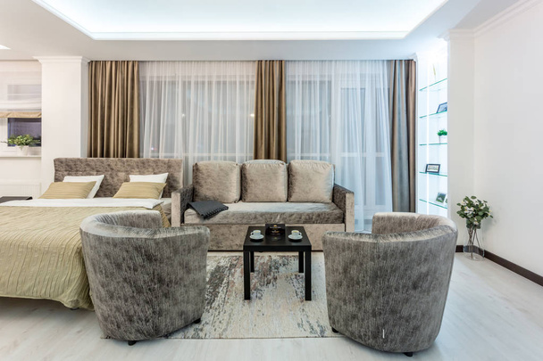 MINSK, BELARUS - January, 2019: luxure hall interior loft flat apartments with tv sofa and armchairs - Zdjęcie, obraz