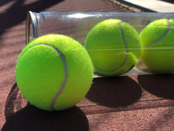 Tennis balls on a tennis court in different designs in a abstract form with creative lighting - Photo, Image