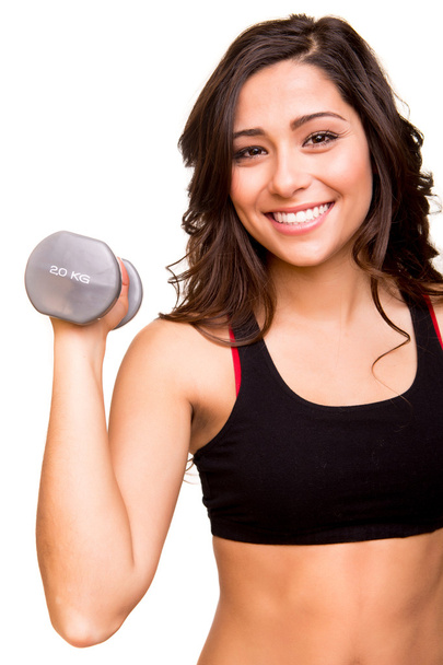 Beautiful fitness woman lifting weights - 写真・画像