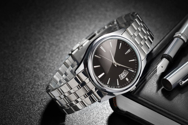 Steel wristwatch on black background - Photo, Image