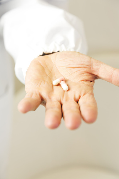 Doctor holding pills against anxiety - Photo, Image