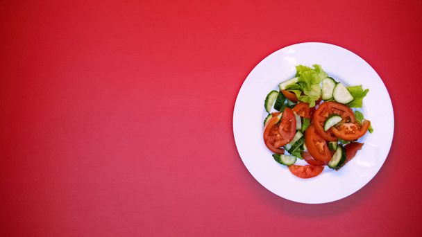 Vegetable salad on white plate bright background, healthy nutrition, vitamins - Foto, Imagem