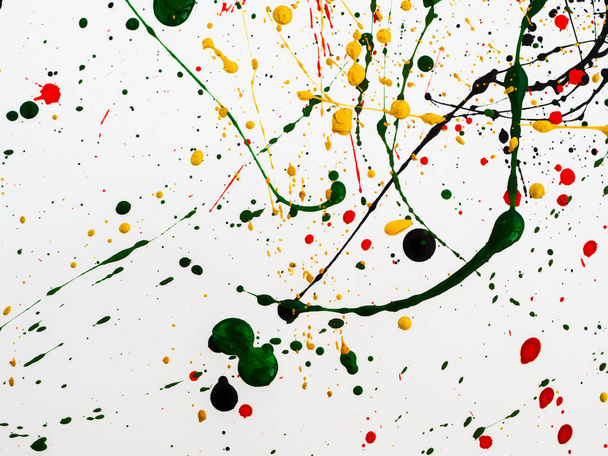 Splashes on red and black and green and yellow paint
 - Фото, изображение
