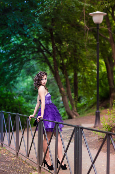 Beautiful young girl in a beautiful dress outdoor - Фото, зображення