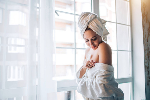 Slim sexy woman in bathrobe and towel on head - Фото, изображение