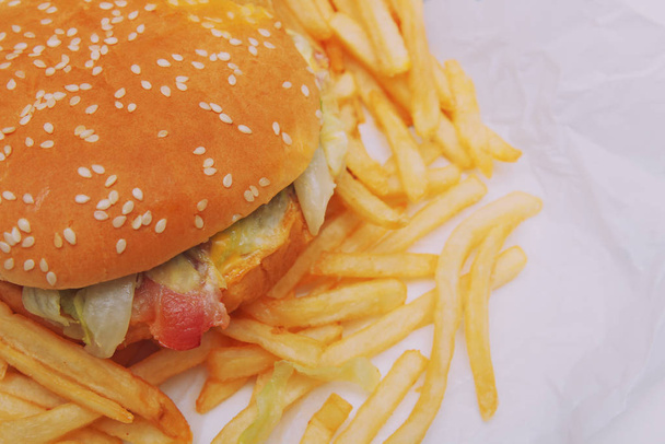 Hamburger and french fries. Unhealthy food, fast food, Food delivery concept - Photo, Image