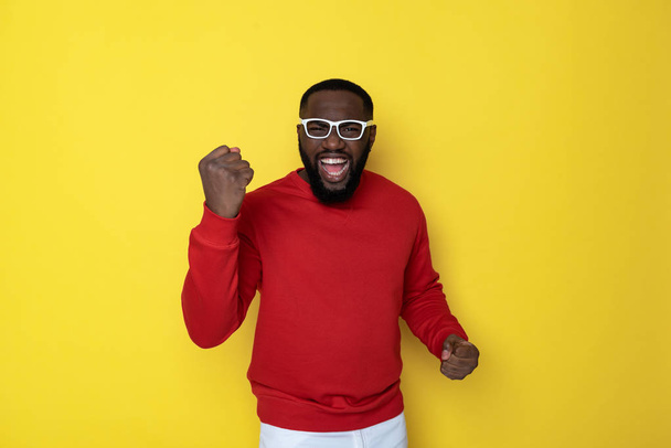 Half length of happy African man with funny eyeglasses posing in studio - Fotó, kép